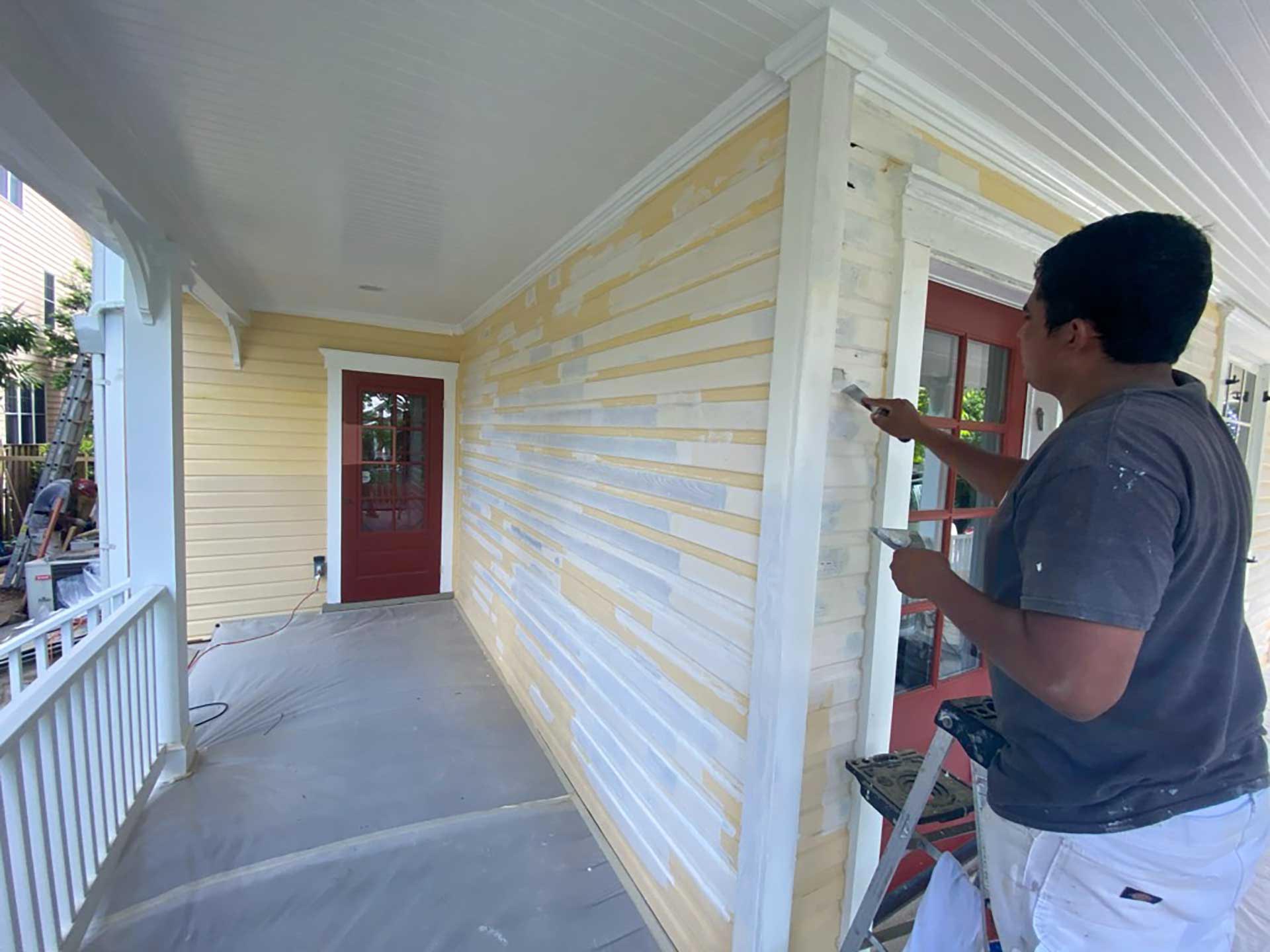 Home exterior siding during commercial painting process