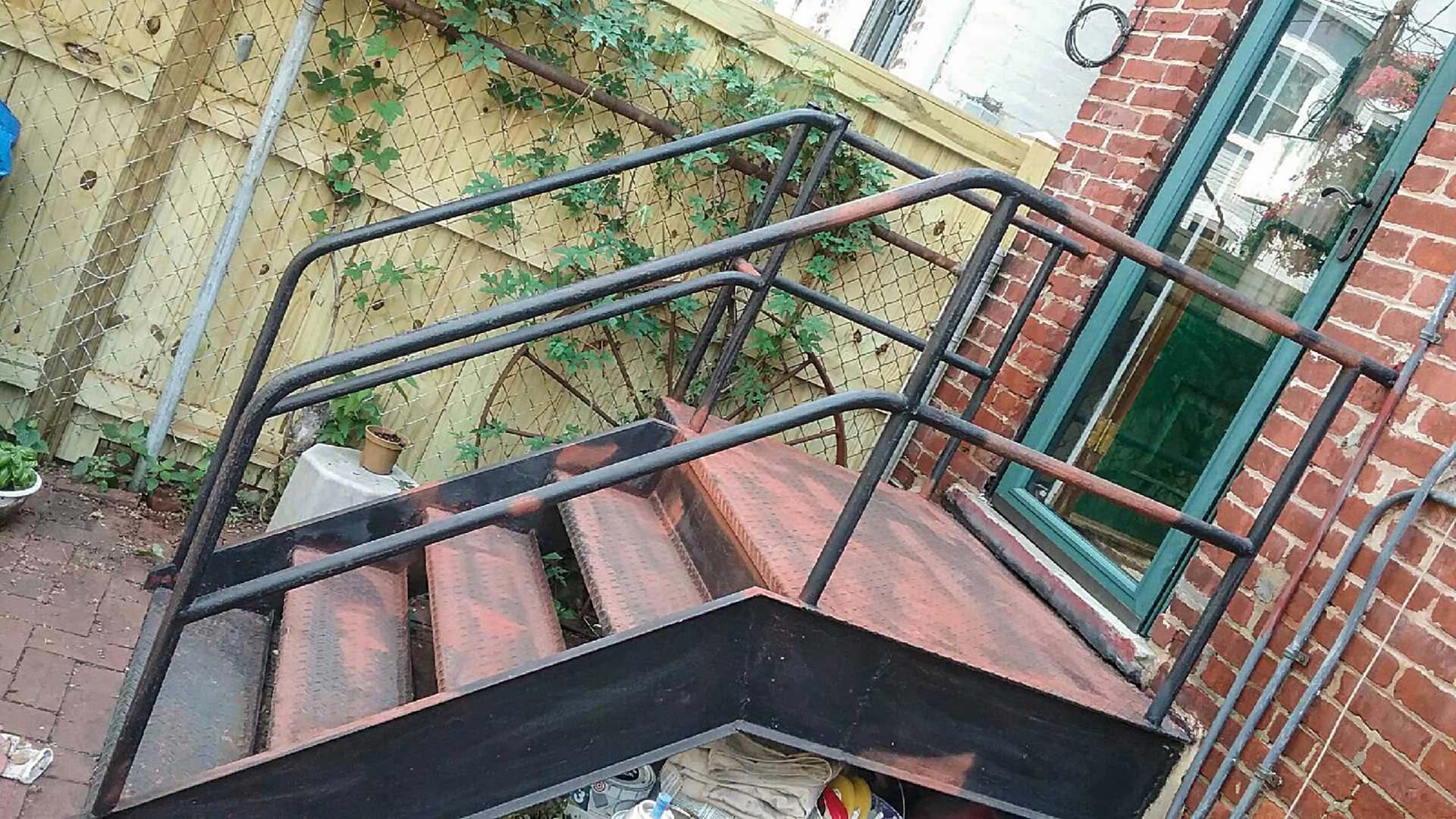 A metal staircase before painting, one of our residential painting services